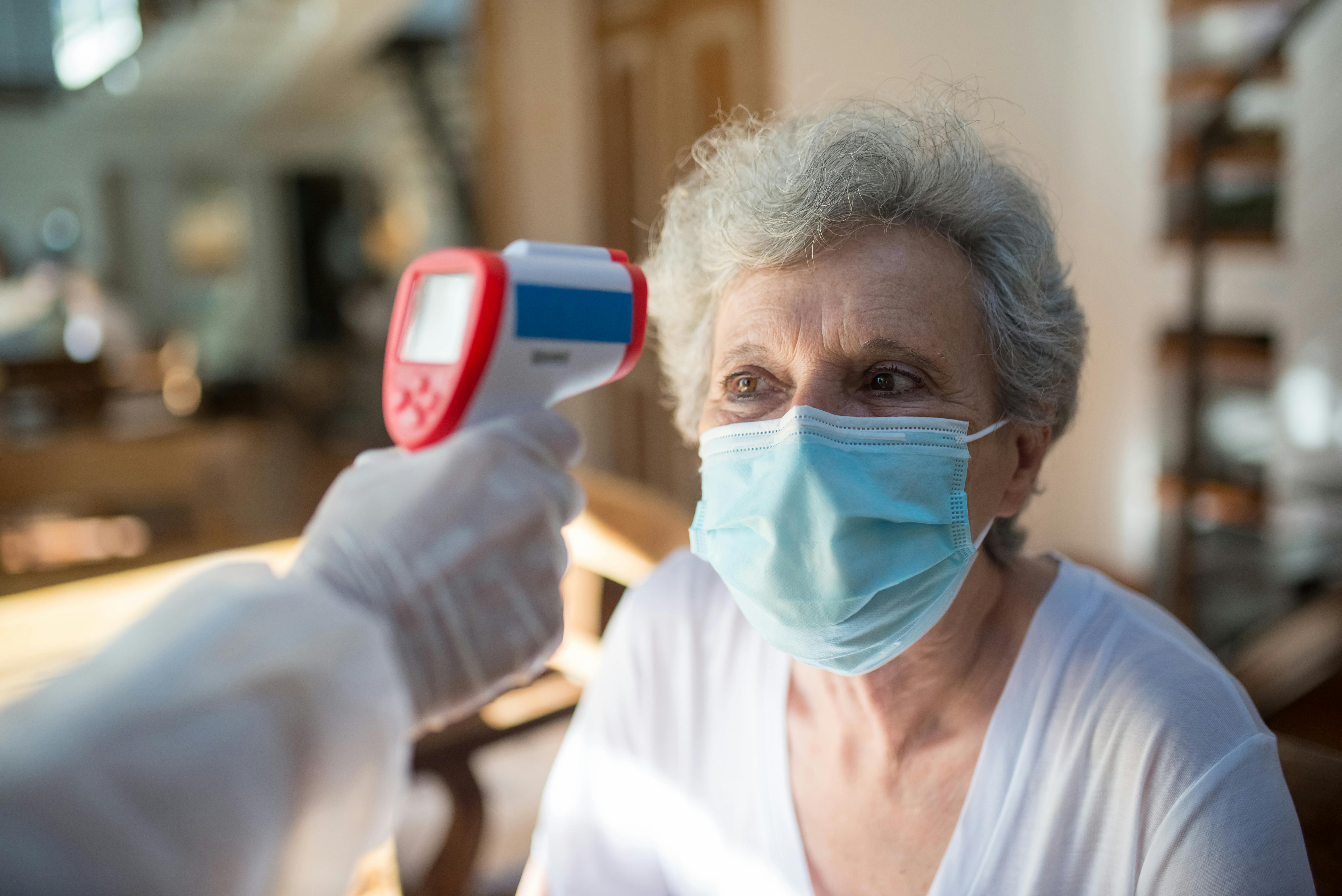 Nurse administering vaccination at home to a patient in Delhi NCR